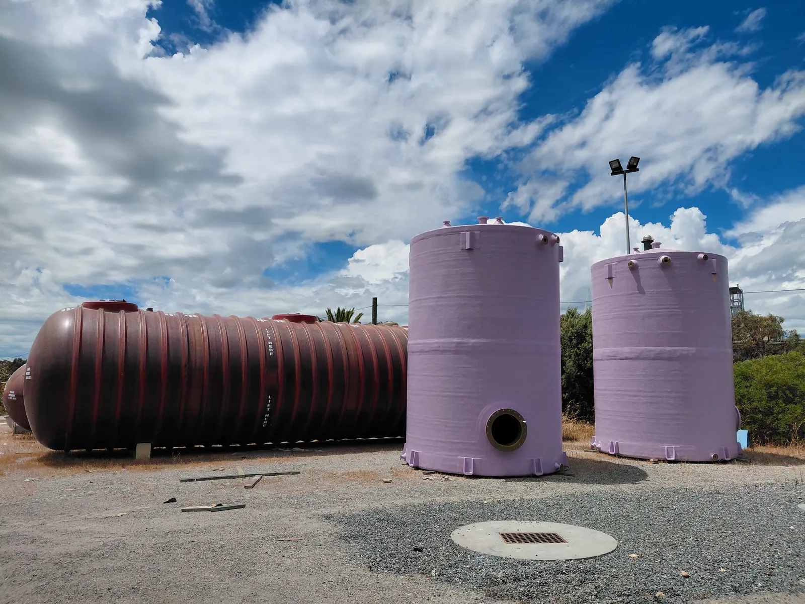 A horizontal FRP tank and two vertical FRP tanks in the GRP yard