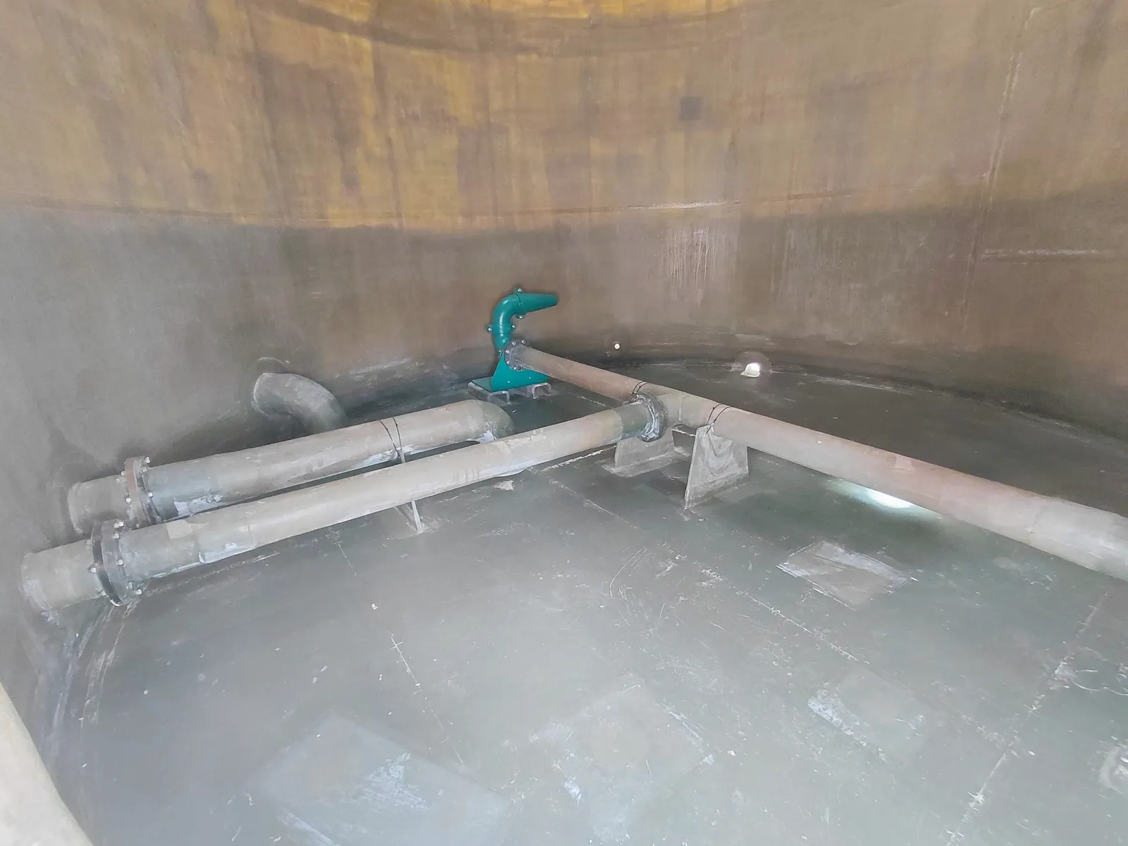Inside an FRP tank, showing the smooth inner surface and internal pipework